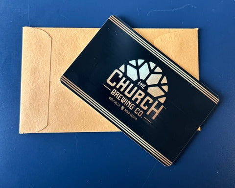 Black card with 'The Church Brewing Co' logo on a blue surface